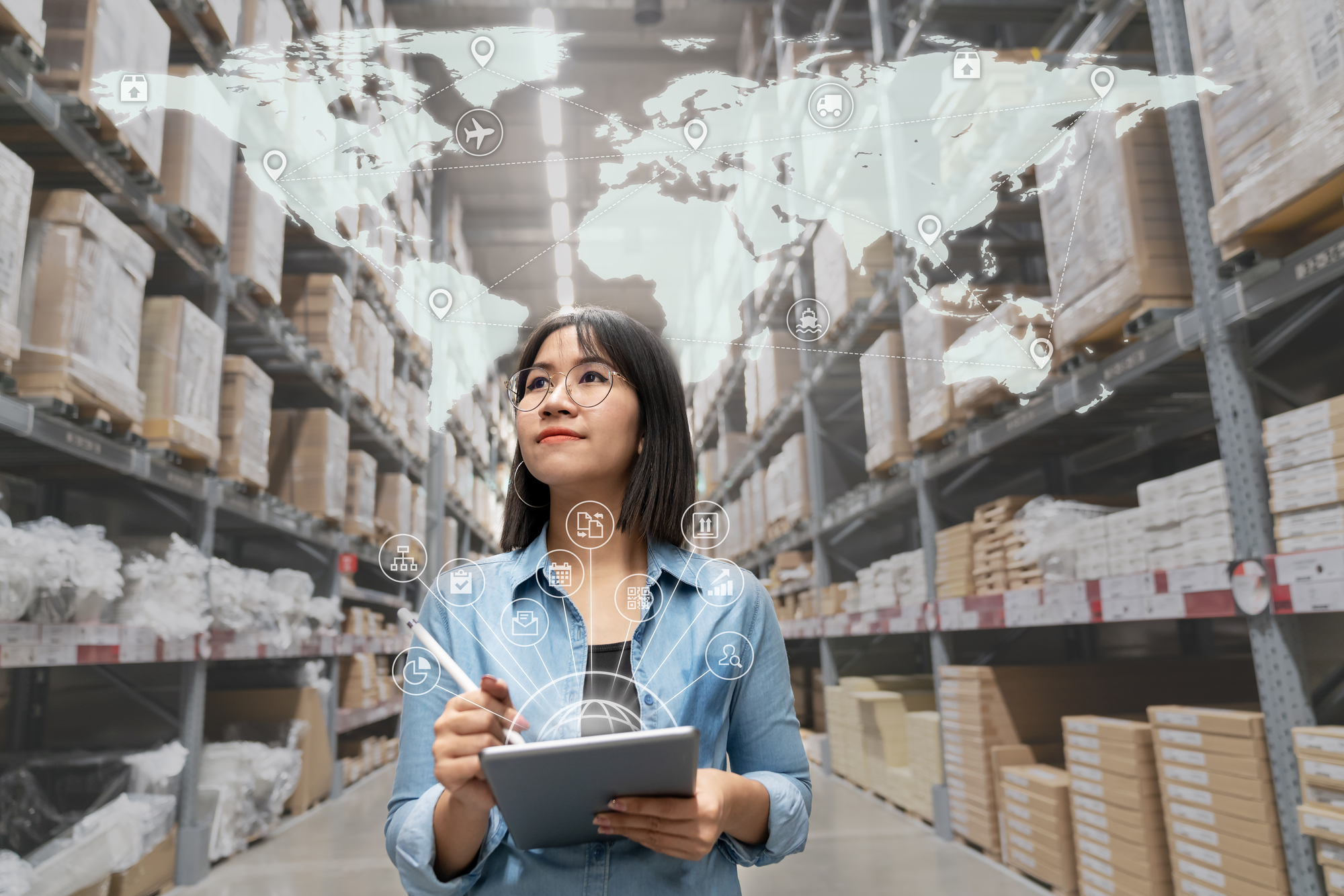 A woman holding a tablet in a warehouse